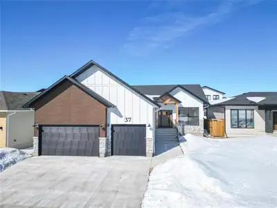 B08//Brandon/This stunning custom-built bungalow by R&M Homes offers 1,669 sq ft of beautifully fini...