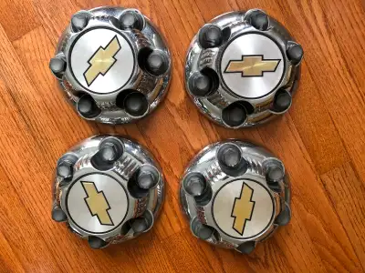 THESE ARE 4 BRAND NEW NEVER USED ORIGINAL OEM FACTORY GM PARTS THAT WILL FIT 16" 17"CHROME WHEELS ON...