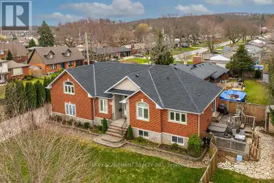 Custom-built bungalow with open concept layout featuring a maple kitchen with stainless steel applia...