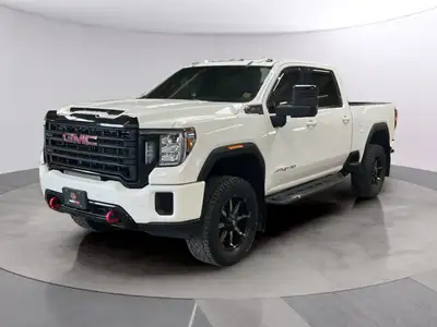 The 2021 GMC Sierra 3500HD AT4 in stunning white offers a robust 4x4 drivetrain complemented by prec...