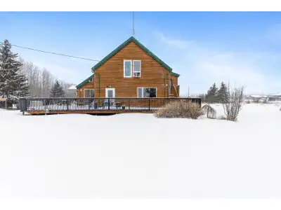 Embrace the ultimate rural escape on this expansive 39-acre estate, featuring a unique split-log sid...