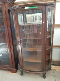 Vintage bow front display cabinet with key.