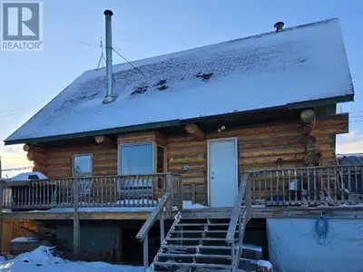 3-bed, 1-bath detached 1.5 storey home featuring a rustic log exterior finish that sits on a 5500 sq...
