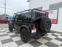 A rugged four-door SUV with iconic styling, manual transmission, and strong 4x4 capability, offering... (image 5)