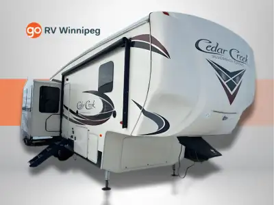 The Cedar Creek Silverback 29IK fifth wheel by Forest River offers triple slides and a rear entertai...