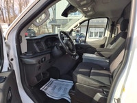 The 2023 Ford Transit Cargo Van, clad in a clean white finish and equipped with rear-wheel drive, of... (image 8)