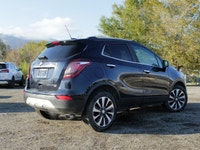 Introducing the 2022 Buick Encore Preferred AWD, a striking black SUV that combines all-wheel drive... (image 1)