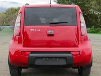 The 2011 Kia Soul 2u in a vibrant red with front-wheel drive is a vehicle built for handling the dem... (image 3)