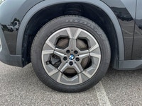 The 2025 BMW X1 xDrive28i arrives as a striking black Sport Utility vehicle, seamlessly blending ath... (image 9)