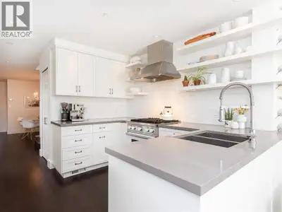 Welcome to this waterfront property in the exclusive Kits Point community featuring mountain, city a...