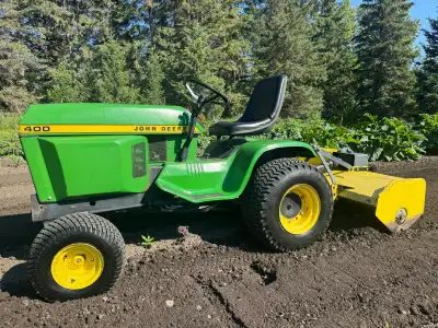 John Deere 400 with rototiller, snowblower, and 60" mowing deck., View more