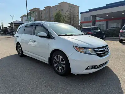 2014 Honda Odyssey Touring — White exterior, Brown interior. This Odyssey is powered by a 3.5L V6 th...