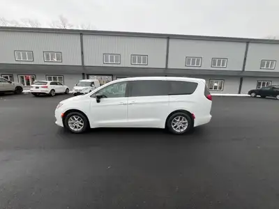 Experience the 2024 Chrysler Grand Caravan SXT in a pristine white finish, complete with efficient f...