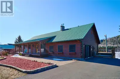 Experience the peace and beauty of waterfront living in this warm & welcoming log home on the scenic...