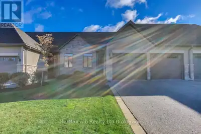 Experience tranquility and convenience in this exquisite Goodman Homes bungalow condo in NE Woodstoc...