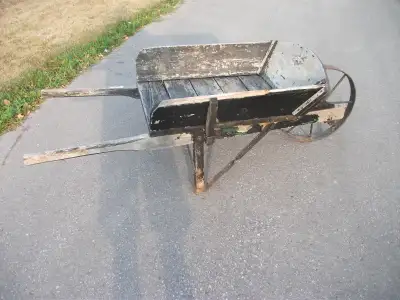 Vintage wooden wheelbarrow in good condition and with 20" steel wheel and removable racks 150.00 at...