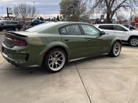 Introducing the dynamic 2023 Dodge Charger Scat Pack 392 Widebody in a striking green, complemented... (image 4)