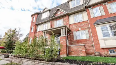 Skip the high-rise elevators. This stacked townhouse offers maximum privacy, direct garage access, a...