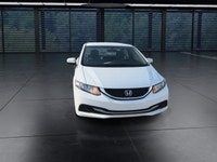 The 2014 Honda Civic Sedan LX, in a pristine white finish and equipped with a smooth front-wheel-dri... (image 2)