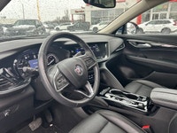 The 2023 Buick Envision Essence, presented in a sophisticated Gray finish, masterfully blends luxuri... (image 5)