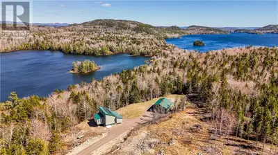 Tucked away on approximately 6 acres with 500 feet of frontage on serene Little Chamcook Lake, this...