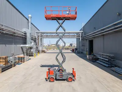 Rough terrain scissor lift built to work on uneven outdoor ground. Its 41 ft platform reaches a 47 f...