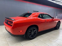 Meet the 2022 Dodge Challenger GT in a vibrant orange finish, gracefully combined with an AWD drivet... (image 7)