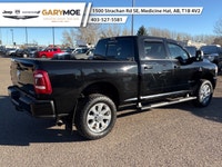 The 2023 Ram 2500 Laramie, in a striking black finish and equipped with a robust 4x4 drivetrain, pro... (image 2)