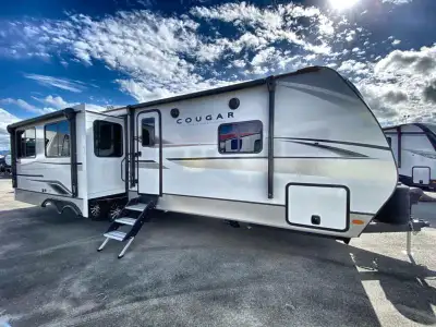 Keystone Cougar Half-Ton travel trailer 29RLPWE highlights: King Bed Full Bath Kitchen Island Two 10...