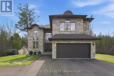 Set on over 2.3 acres of private, tree-lined land, this custom-built 3200+ sq ft home plus a fully f...