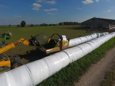 Large square bale processor that mounts on your skid steer, tractor loader, or telehandler combining...