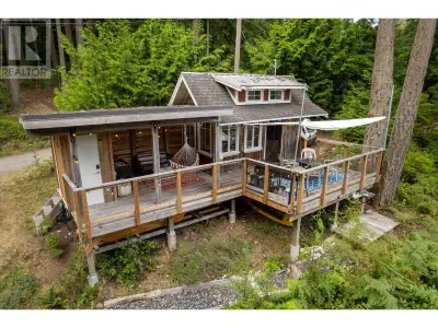 The tiny home sleeps 4 with a 200-amp electric panel and a covered outdoor kitchen with outdoor show...