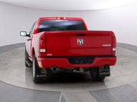Introducing the Ram 1500 Classic Express 4x4 Crew Cab, a striking red truck that blends power and ca... (image 3)