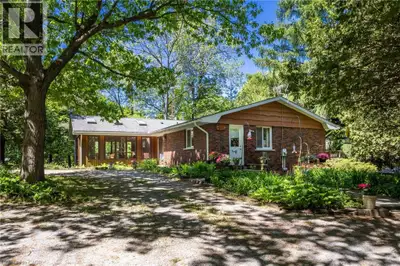 Situated on a magnificent, wooded lot that is almost a full acre in size, this bungalow offers immen...