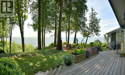 Experience the ultimate in West Coast waterfront living. This beautifully renovated home is prominen...