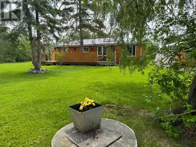 Enjoy this Cute and Cozy Home or Cottage One Lot Back Across from Canal Lake. Just a Short Distance...