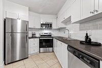 Fully renovated spacious suite features kitchen with modern features and finishes including laminate... (image 7)