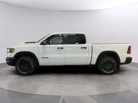 The 2026 Ram 1500 Rebel 4x4 Crew Cab 57 Box is ready to impress with its striking white finish and r... (image 1)