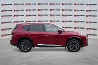 The 2025 Nissan Rogue Platinum, in striking Red, offers a sophisticated driving experience with only... (image 6)