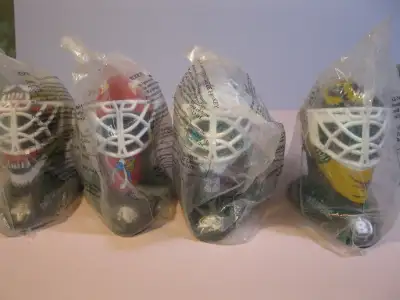 Four sealed McDonalds goalie masks, Colorado, Panthers, Bruins, Blackhawks.