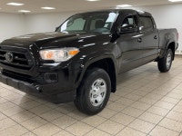 The black paint drinks in daylight like ink, casting sharp reflections across muscular fenders while... (image 1)