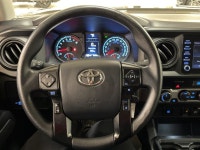 The black paint drinks in daylight like ink, casting sharp reflections across muscular fenders while... (image 9)