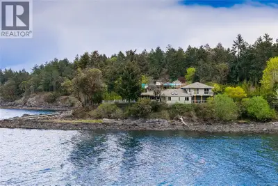 Set on a stunning 1.39-acre low bank waterfront lot with desirable southern exposure, this rare and...