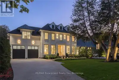 Walk to downtown Oakville from this 2024 custom-built residence, third house from Lake Ontario on a...