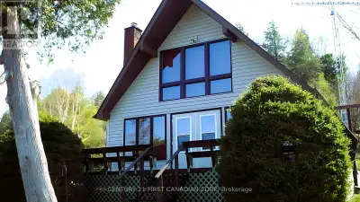 A Piece of Paradise describes this cozy cedar tongue and groove Lakefront Home on an acre of land wi...