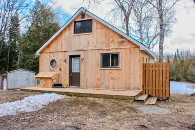 a step into nature without outside intrusions. This quaint off-grid cabin in the woods overlooks its...