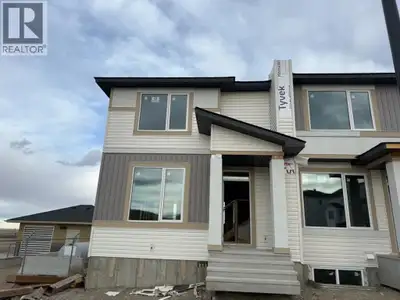 This new construction triplex Home in the Town of Crossfield AB that is under construction and sched...