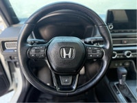 The 2025 Honda Civic Sedan Hybrid Sport in a stunning white finish combined with its FWD drivetrain... (image 9)