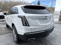 The 2026 Cadillac XT5 Sport AWD, finished in Crystal White Tricoat with a rich Kona Brown interior w... (image 5)