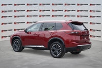 The 2025 Nissan Rogue Platinum, in striking Red, offers a sophisticated driving experience with only... (image 2)